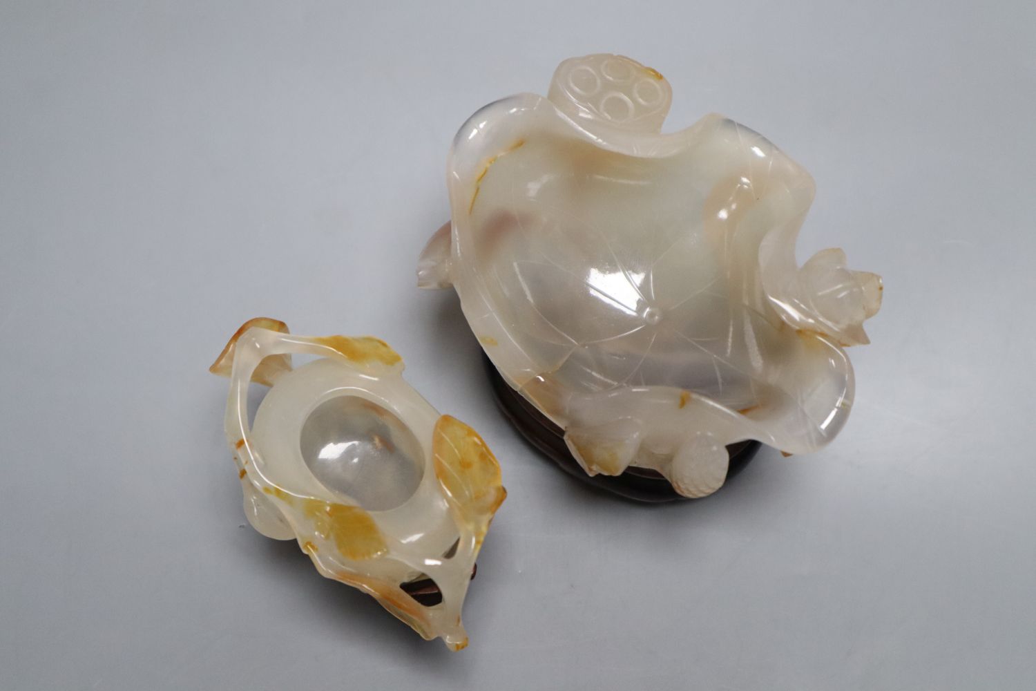 Two Chinese carved agate brushwashers on stands, largest 10cm